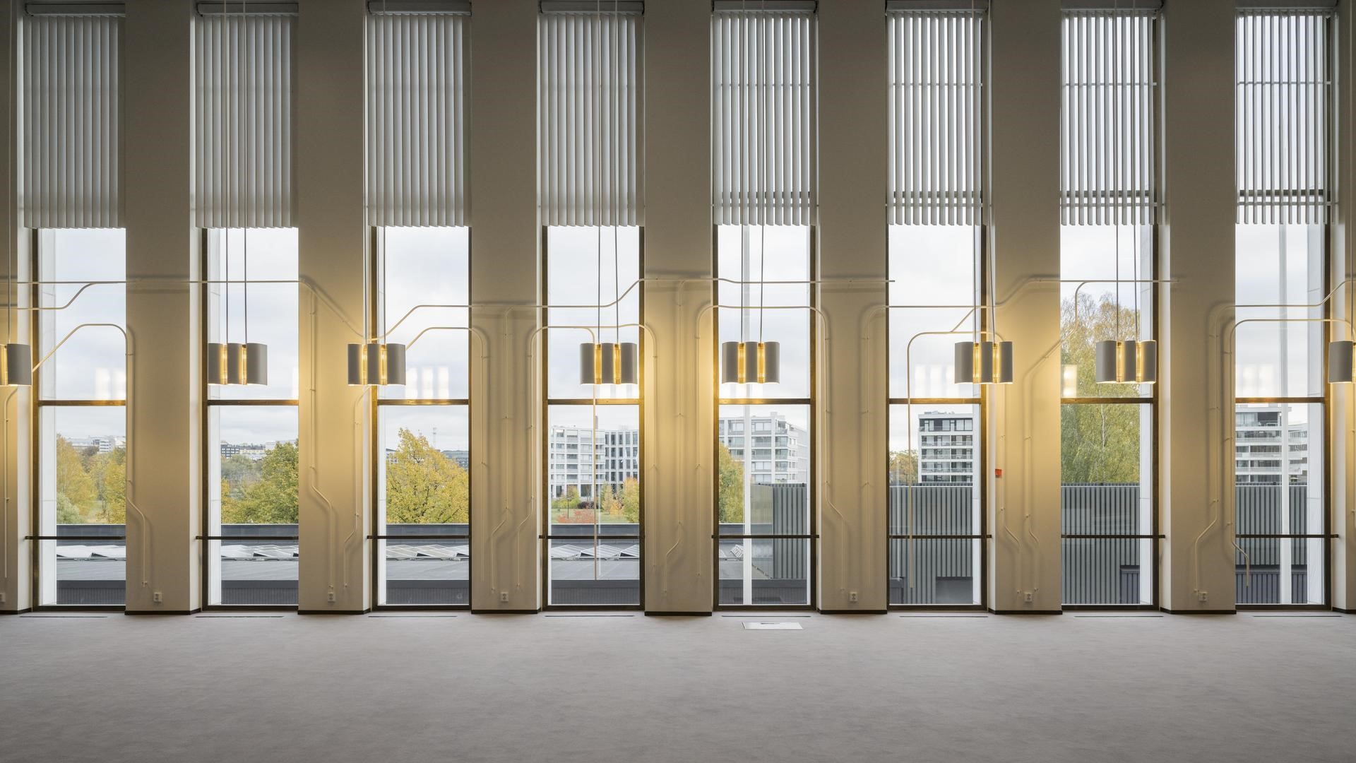 An interior wall with several windows and LED lamps in between
