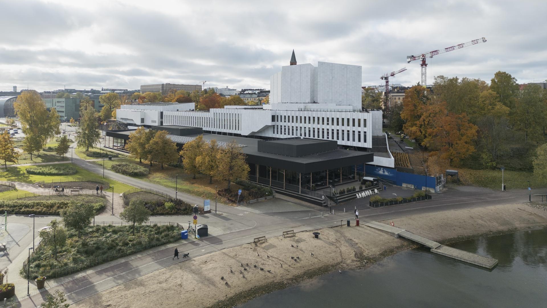 Aerial view of Finlandia Hall’s white marble building surrounded by trees and nearby structures