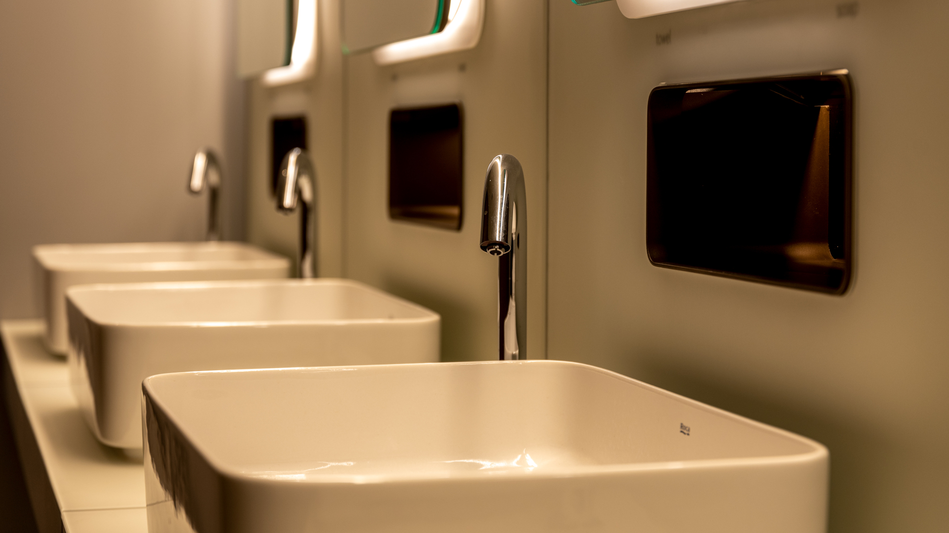 Photograph of hand basins with mirrors above them